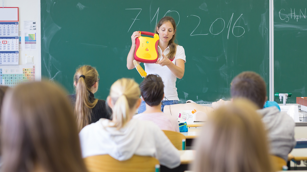 a teacher showing AED