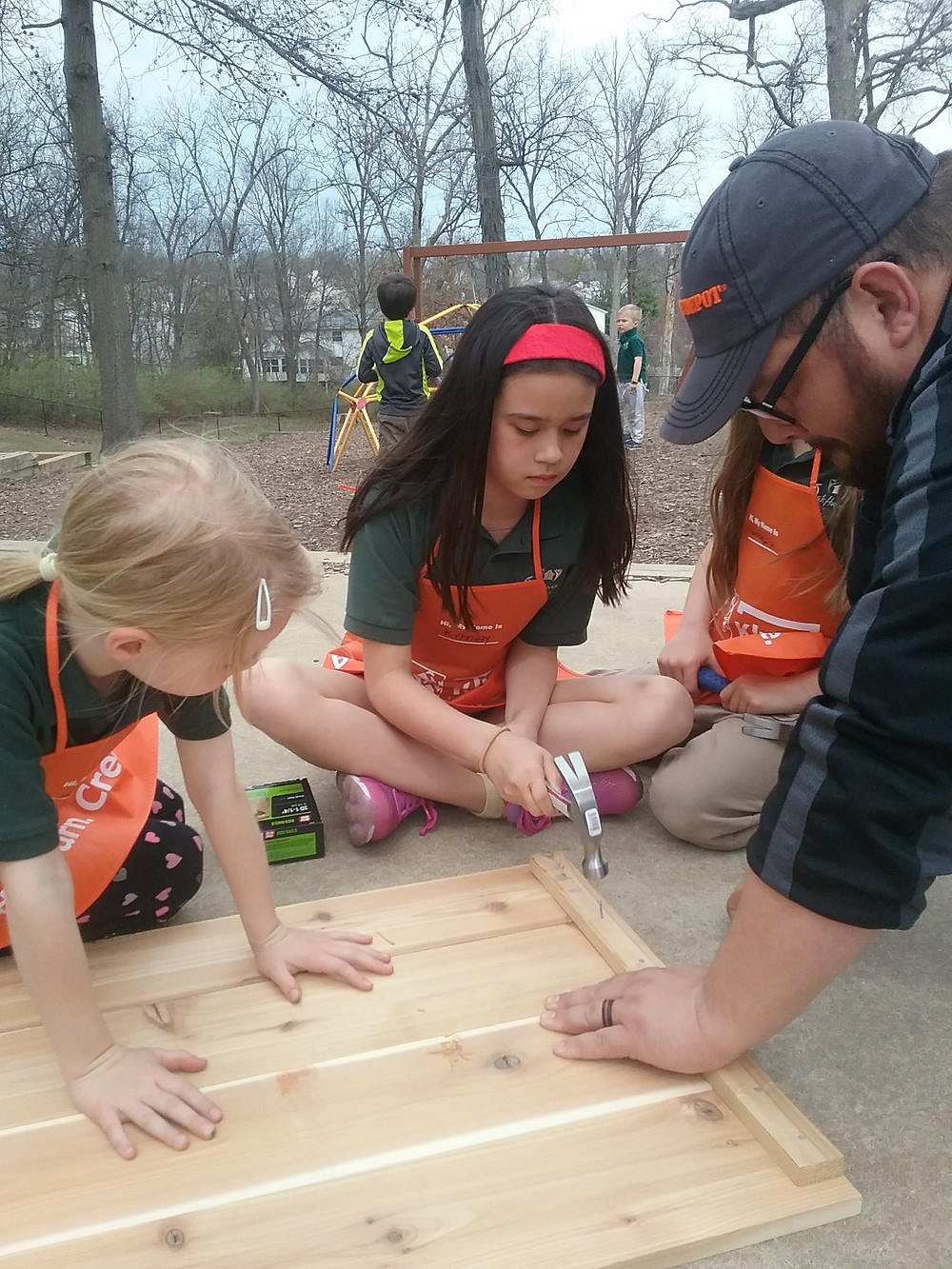 Students nail together garden box.
