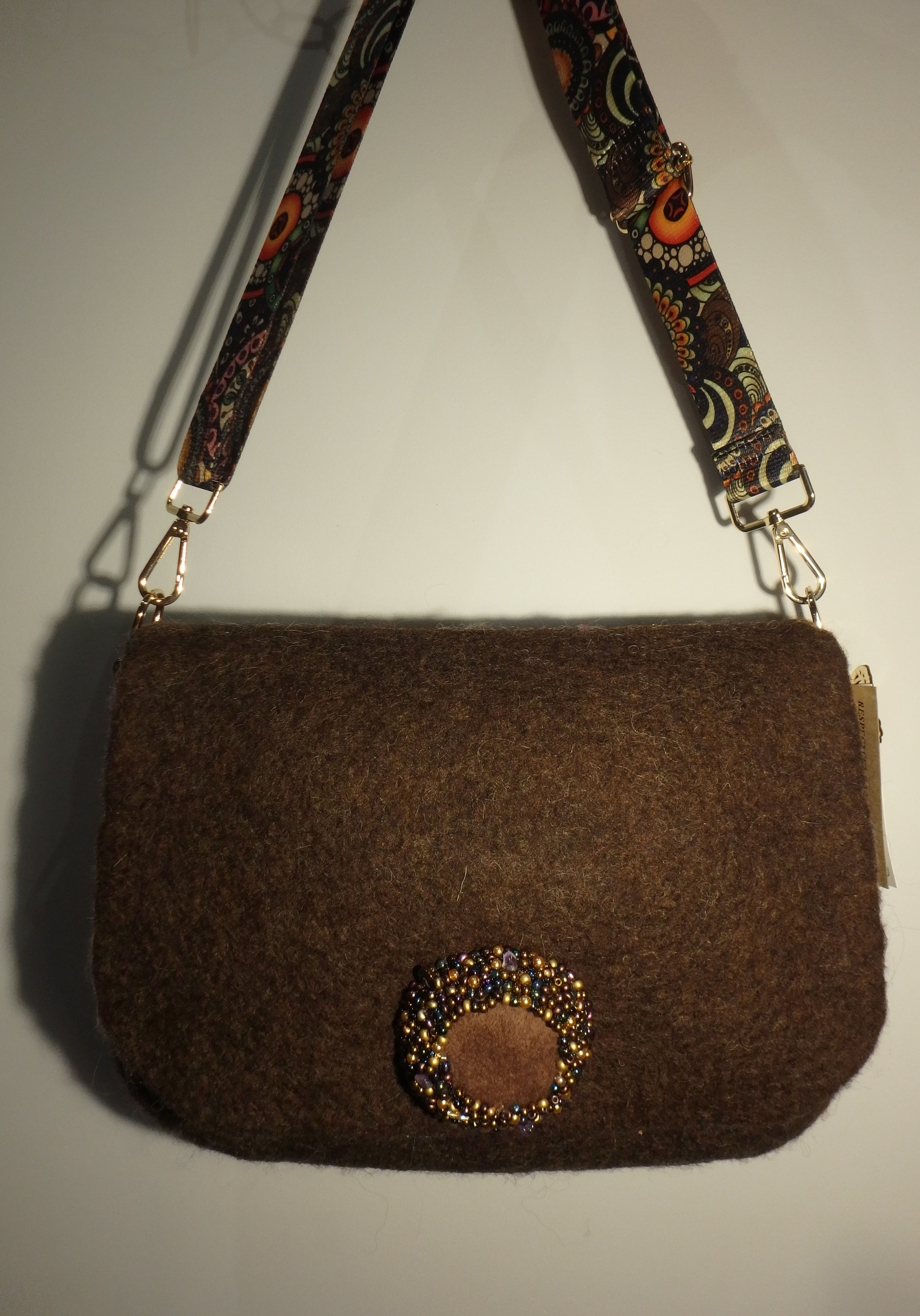 Felted messenger bag with embordered nob.