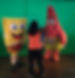 A kids club counselor getting the boys ready for a photo with Sponge Bob & Patrick.