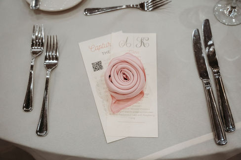 Table setting for wedding, pink rose from napkin