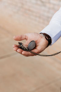 groom holding pocket watch
