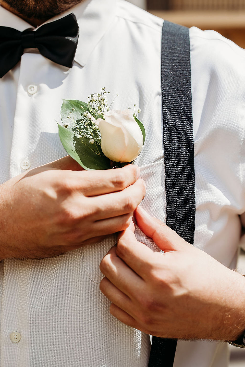groom with white rose boutonnière 