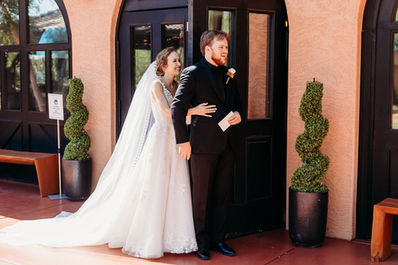 Arizona wedding photographer, groom in black suit, bride and groom first touch, first look