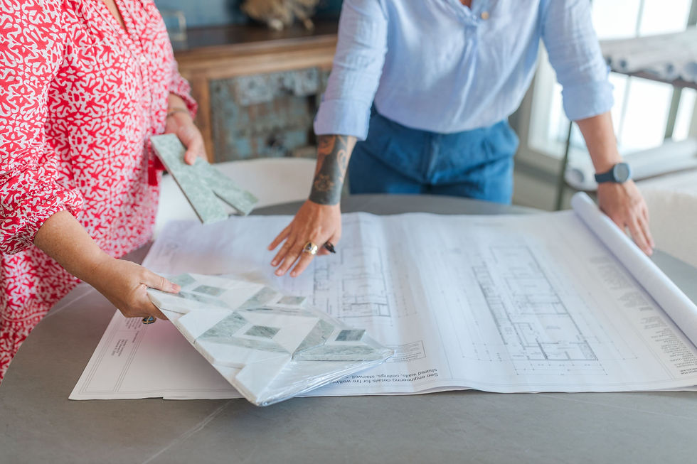 Background image of two people observing a large blueprint that is on a table.