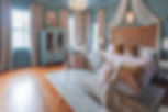 The Gilded Lady Wedding Suite featuring a sofa couch, a wardrobe, and bed.