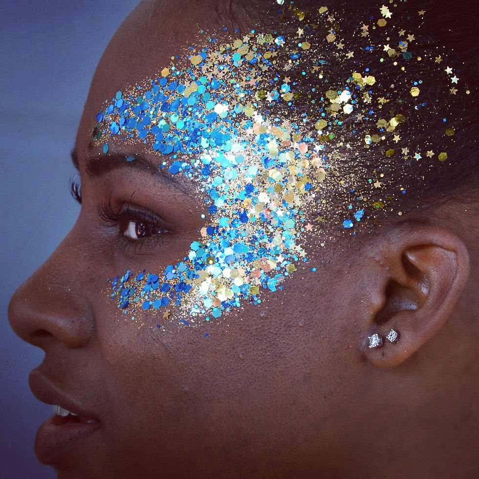 Blue and silver glitter design on a woman's face