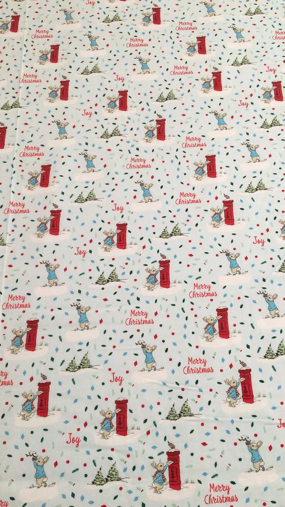 Thumbnail: Video of Peter Rabbit Christmas fabric, featuring Peter posting letter to Santa and other scenes, on a pale blue background.