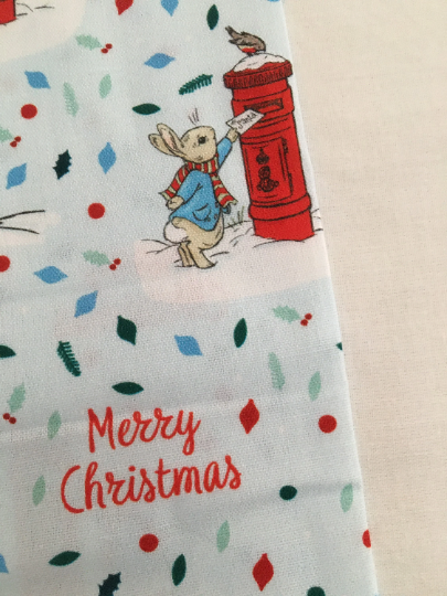 Thumbnail: Peter Rabbit Christmas fabric, Peter posting letter to Santa. Shows colours against white background.