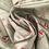 Thumbnail: Robin Christmas fabric, robins sitting on berry branches, with foliage on a sage green background. Fabric in swirled effect.