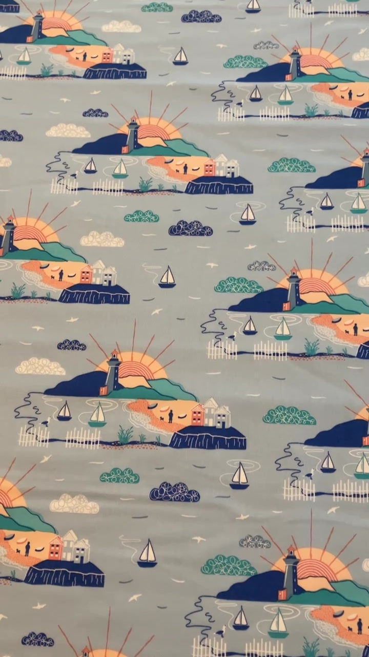 Thumbnail: Video of lighthouse fabric, featuring lighthouse scene, sun shining, boats, etc on a blue background
