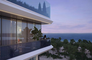 A balcony at Aquino looking over the trees to the sea at dusk