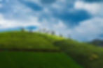 Lush green tea plantation hillside under dramatic monsoon clouds by landscape photographer Arun Siddharth