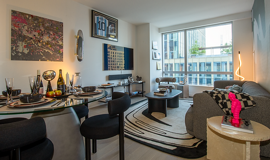 Eclectic modern living and dining room in Downtown Brooklyn condo, featuring sculptural furniture, bold artwork, and city-facing windows. Designed by HOLM Interior Design.
