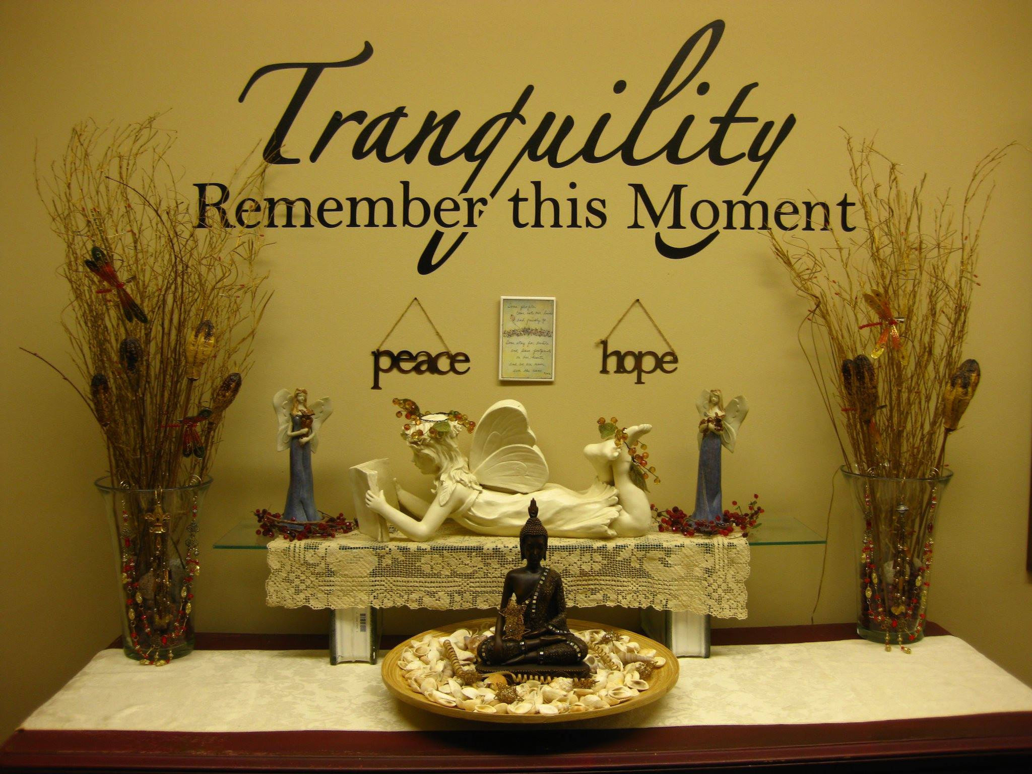 a peaceful setting with a statue of an angel and Buddah