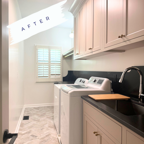 An updated laundry room with herringbone patterned tile on the floor and new custom cabinetry.