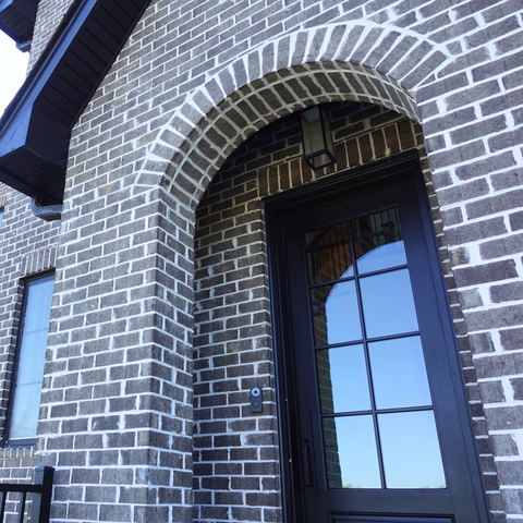 An arched entry to a new construction home