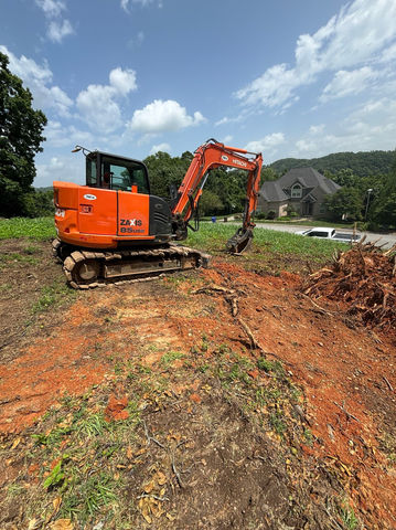 Excavator digging a home site.