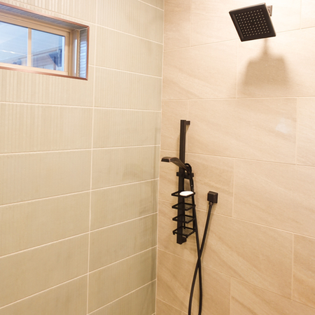 A large walkin shower with transom window. 