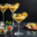 MARTINI GLASS FILED WITH CHEESY GARLI MASHED POTATOES WITH HASSEL BACK POTATOES AND SMALL