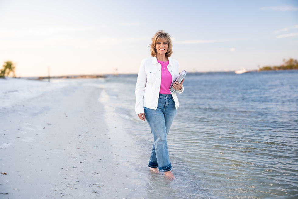 Karen Brooks walking on beach holding the bible