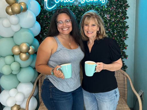 two women drinking coffee