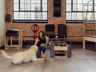 woman and her dog in a Pilates studio