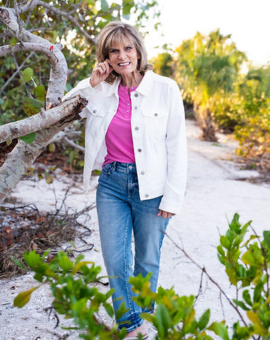 Karen Brooks standing by tree