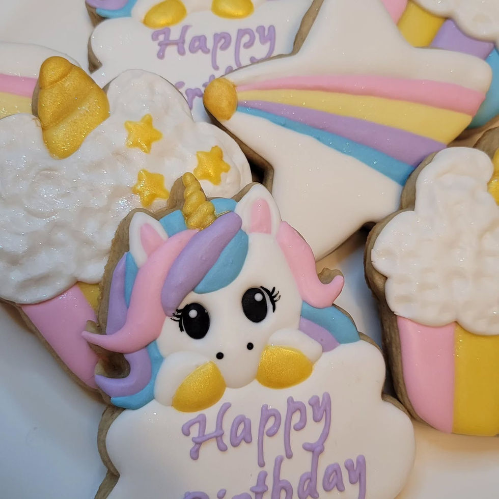 Unicorn and star shaped cookies with pastel frosting and Happy Birthday text