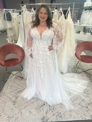 Bride wearing a wedding dress in Shreveport, Bossier City, Minden Louisiana.  Lacey dress with bishop sleeves. Aline tulle skirt and soft train. 