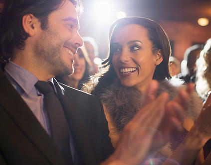 Close up of couple clapping in theater