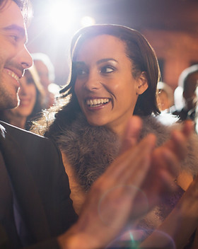 Close up of couple clapping in theater