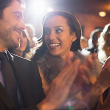 Close up of couple clapping in theater