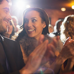 Close up of couple clapping in theater