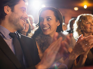 Close up of couple clapping in theater