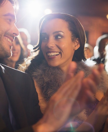 Close up of couple clapping in theater