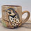 Thumbnail: Cheeky northern flicker in a pear tree hand carved wheel thrown mug