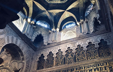 Ornate Islamicate ceiling with sun peeking through windows