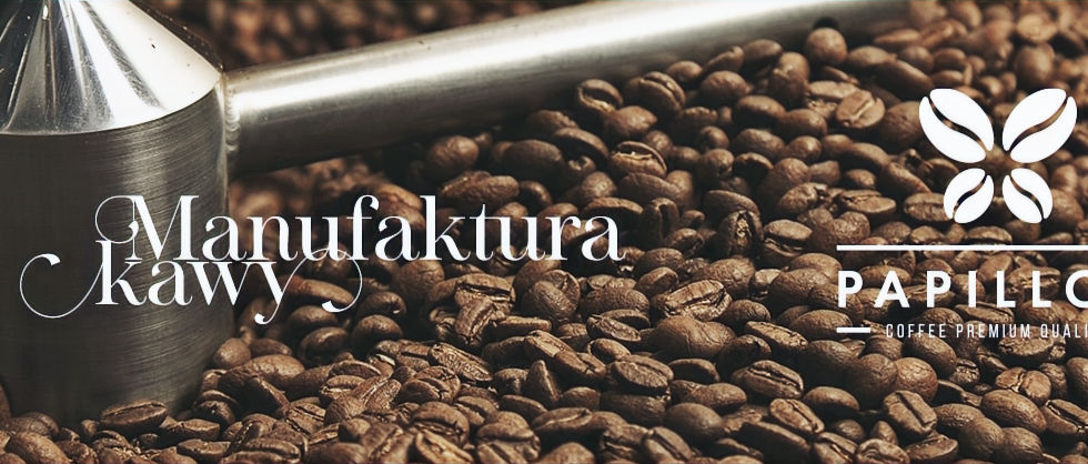 Manufaktura Kawy Papillon logo on coffee beans background, close-up view.