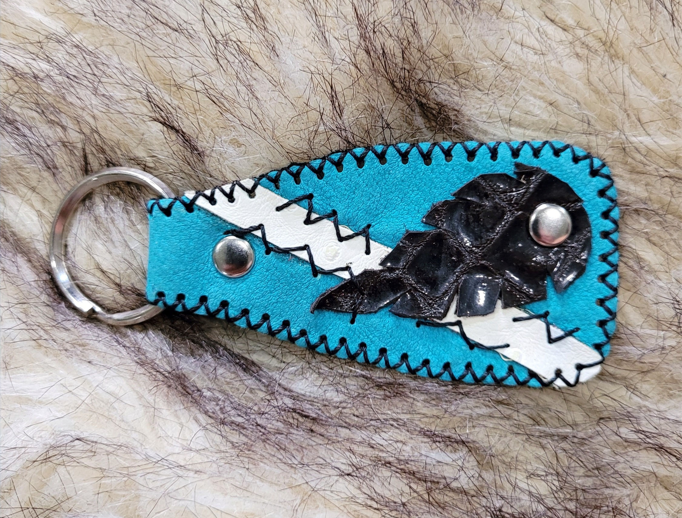 Handstitched Turquoise and White Keychain With Decorative Black Leather Feather