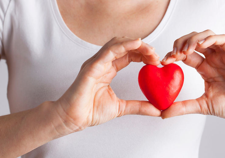Woman holding heart shape, signifying heart health