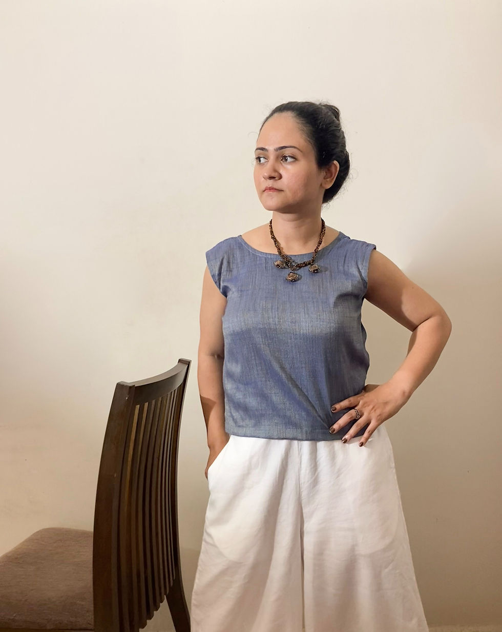 Thumbnail: Full-length styling of a sleeveless silk blend top paired with relaxed trousers for effortless everyday wear