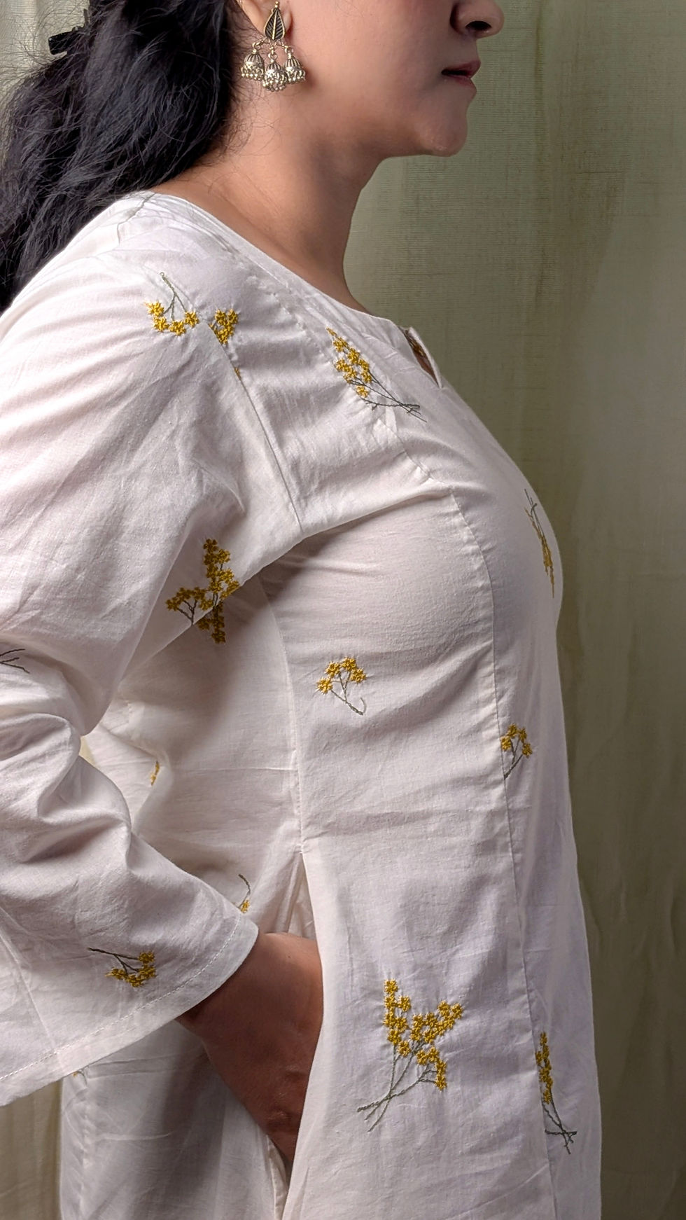Thumbnail: Side view of ivory cotton kalidar kurta with subtle yellow floral embroidery and relaxed silhouette