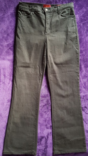A black pair of jeans on a purple back ground