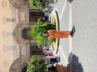 a woman in the middle of the courtyard in a museum