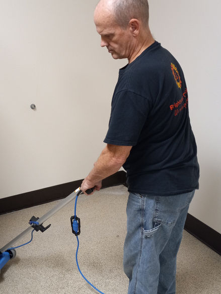 Man using a floor waxing machine