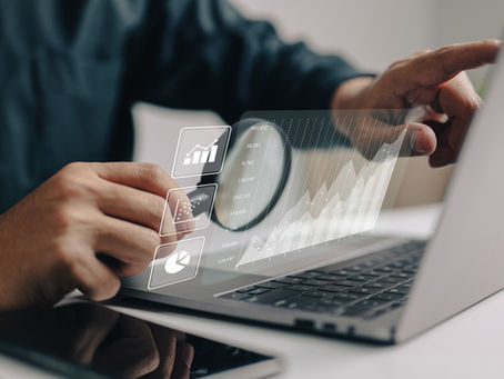 person viewing data with a magnifying glass on a laptop
