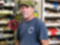 Image of our salesman behind our parts counter with heaps of bins behind him.