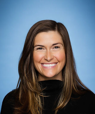 Professional headshot of Kellie, smiling and looking at the camera.