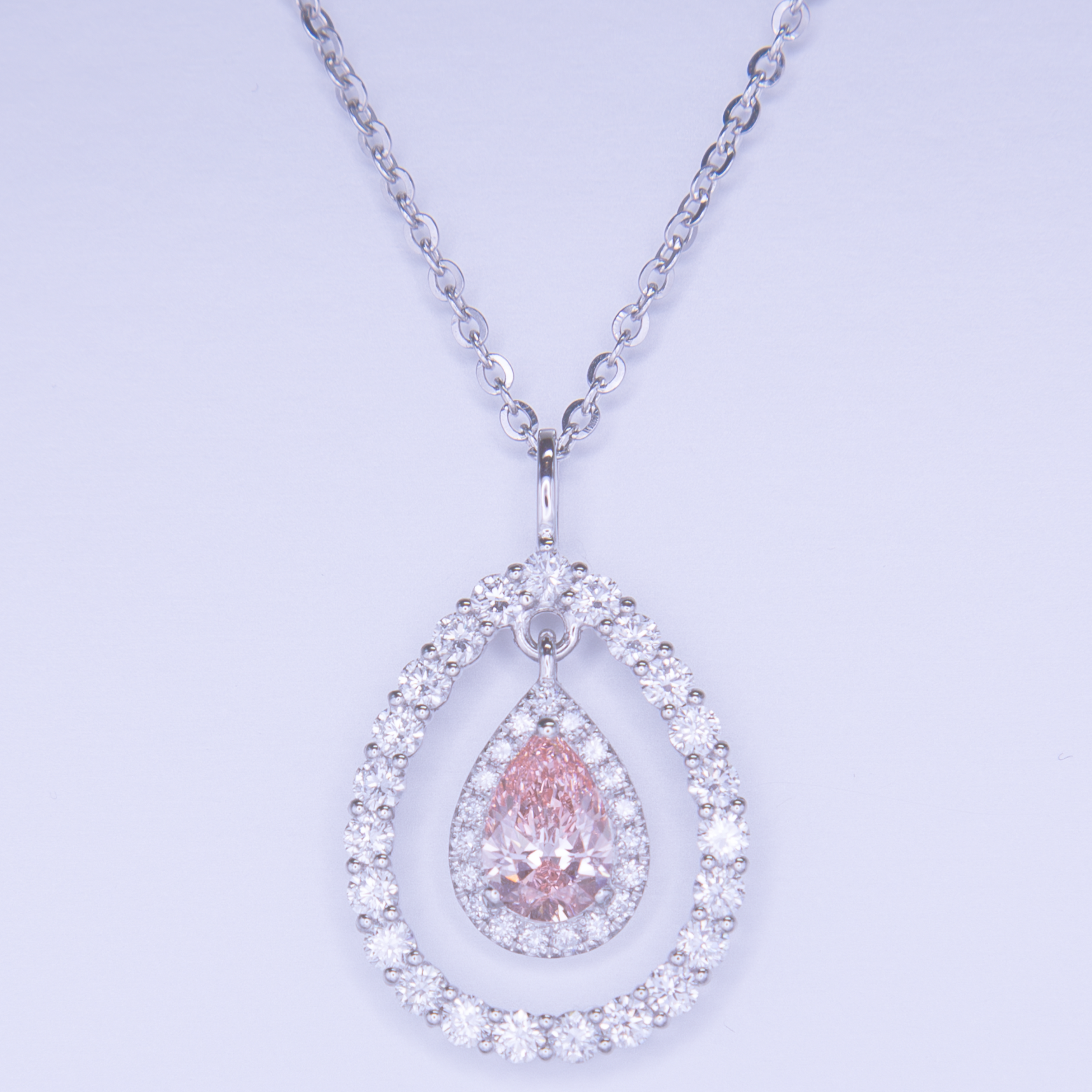 MIYAVI luxury jewelry packaging featuring the ECHO Teardrop Halo Pendant in 18K gold with pink diamond centerpiece.